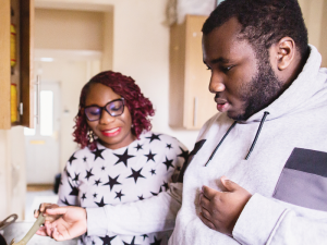 a teenager and his mum cooking together