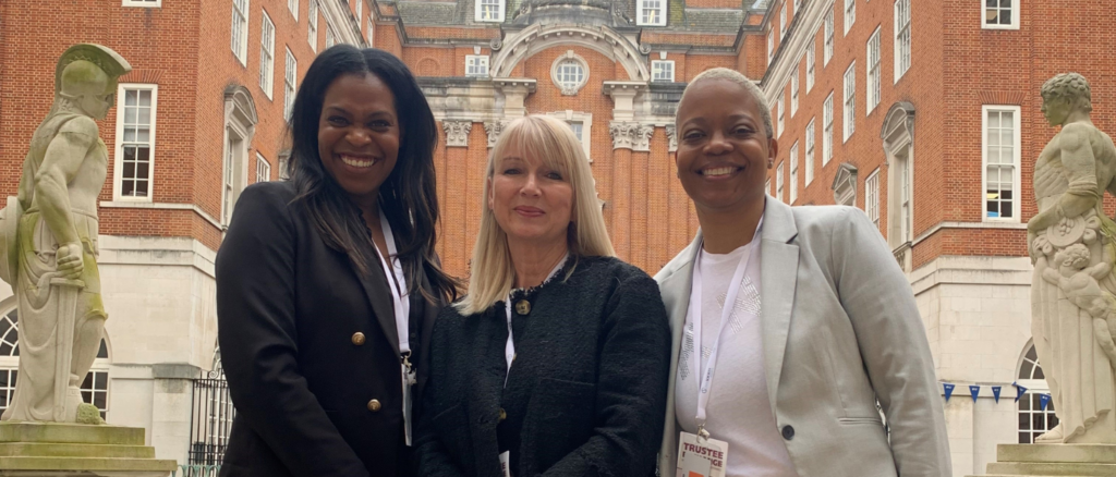 Trustees Emma Pinnock and Marguerite Haye stand either side of Family Fund Chief Executive Cheryl Ward
