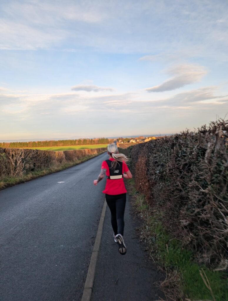 A photo of Michaela training for the Great North Run with her back at the camera.