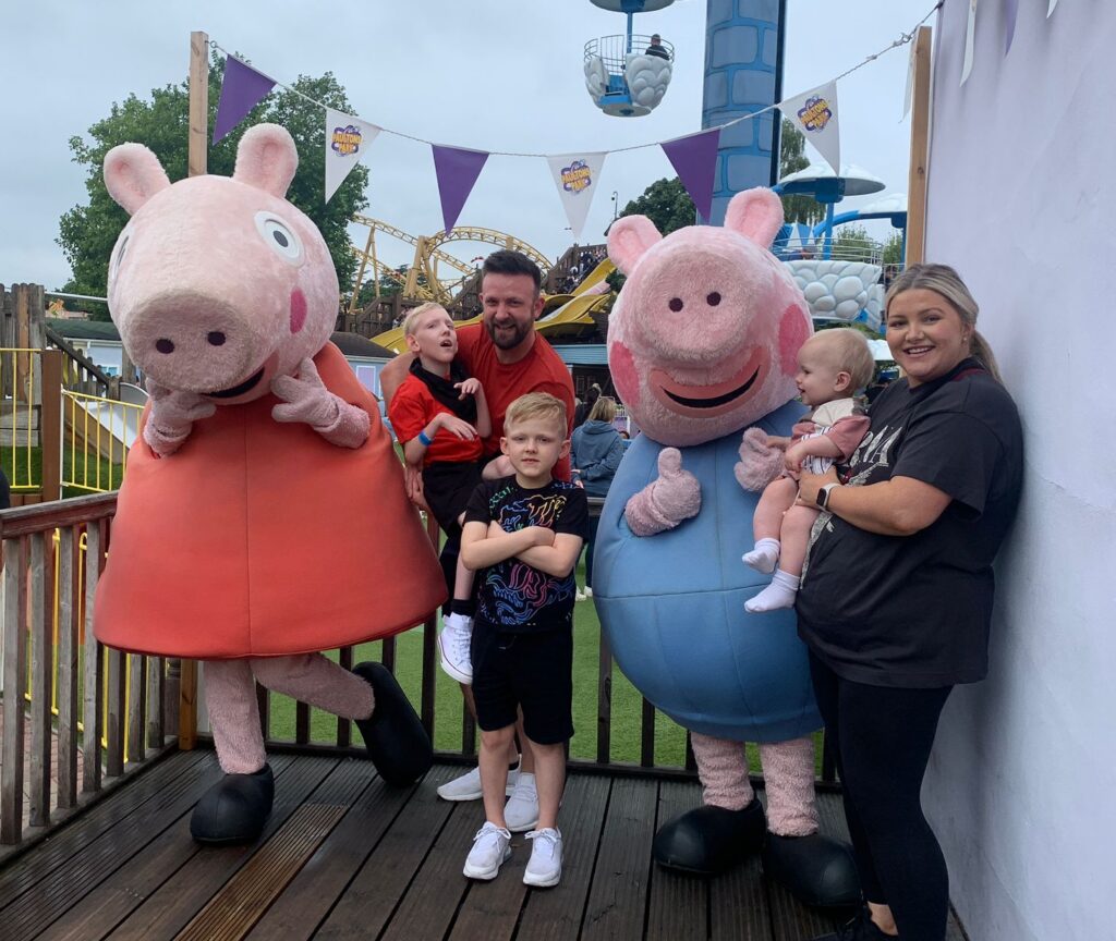 A family of five enjoy a day out at Peppa Pig land.