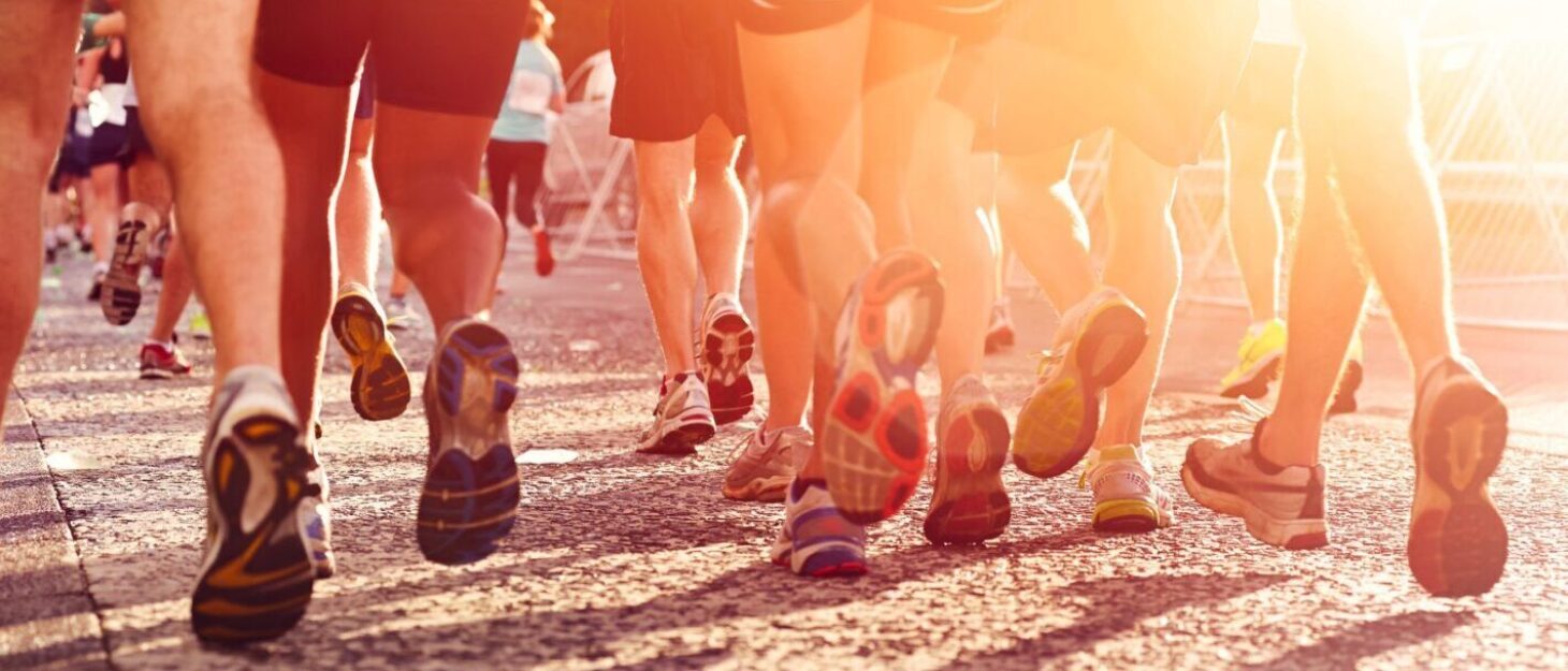 A lot of peoples legs in running trainers during an event