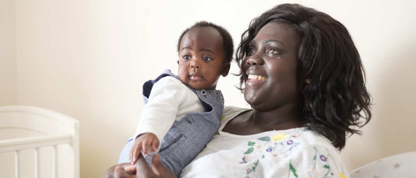 A mum holding a toddler in her arms