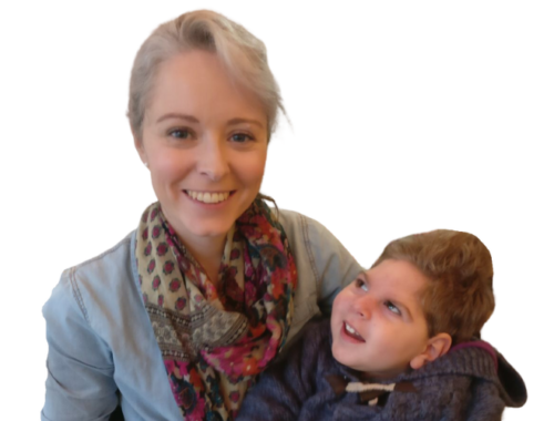 A lady with blonde hair pulled back, wearing a light denim jacket and red spotted scarf, she is holding her son