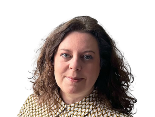 A woman wearing a blouse with dark curly hair