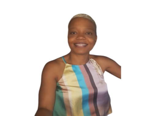 A woman with short bleached hair, wearing a striped top smiling