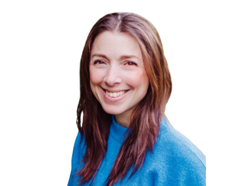 A lady with long brown hair wearing a blue jumper, smiling