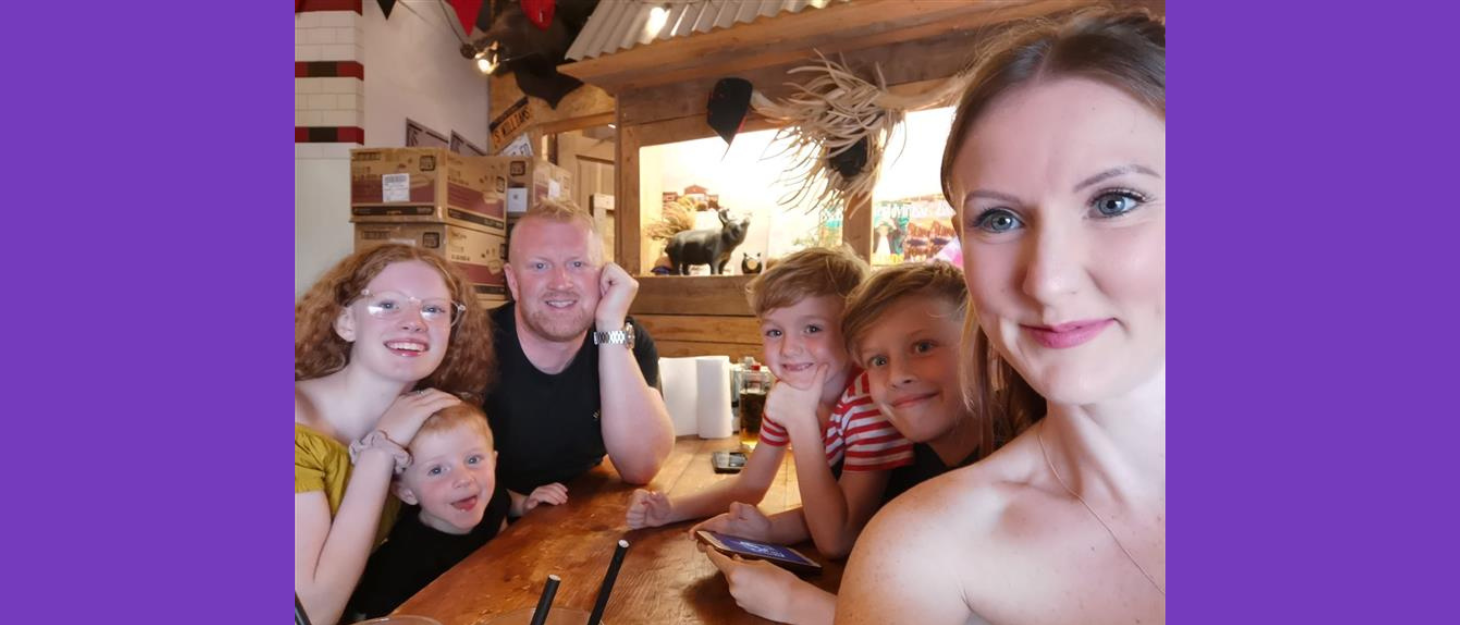 A family selfie around a dinner table